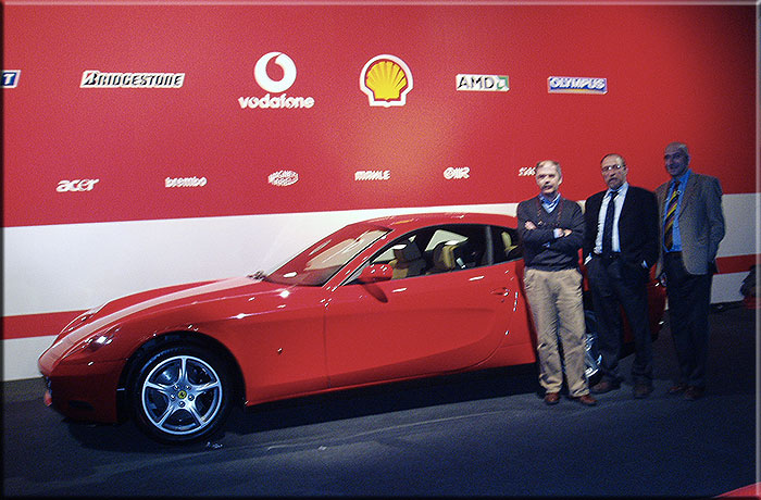 Maranello 26 gennaio 2004. Da sinistra Mauro Del Monte, Piero De Micheli e Robero Arpini in occasione della presentazione della nuova monoposto F2004 posano vicino alla Ferrari 612 Scaglietti presentata pochi giorni prima al salone di Detroit.